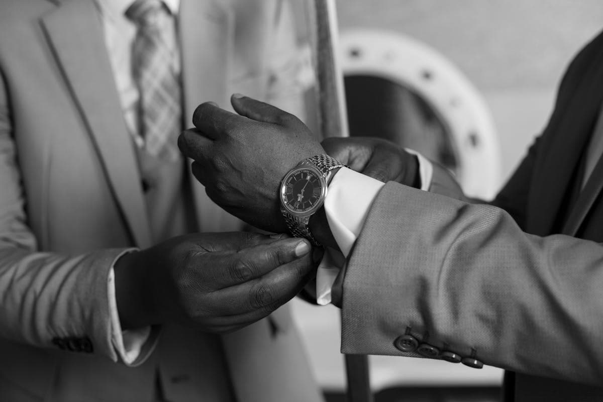 Groom in a well-fitted custom wedding suit adjusting his jacket cuff before the ceremony