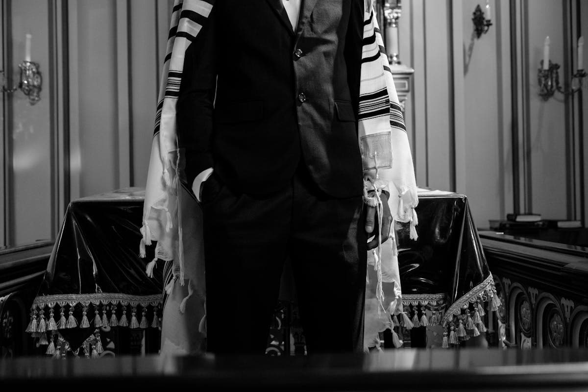 Interior of a synagogue with the Torah ark and bimah, warm light, no people present