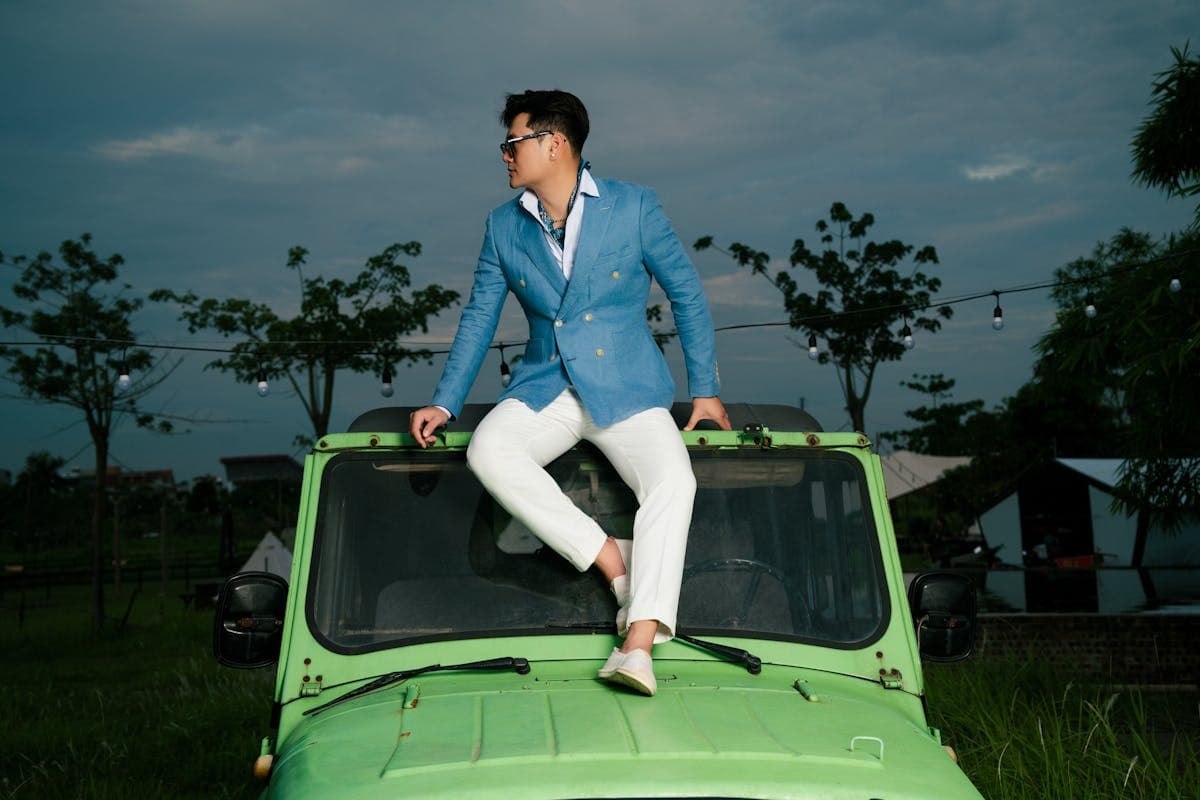 Man in an unstructured linen blazer over an open-collar polo with chinos and loafers, relaxed summer smart-casual