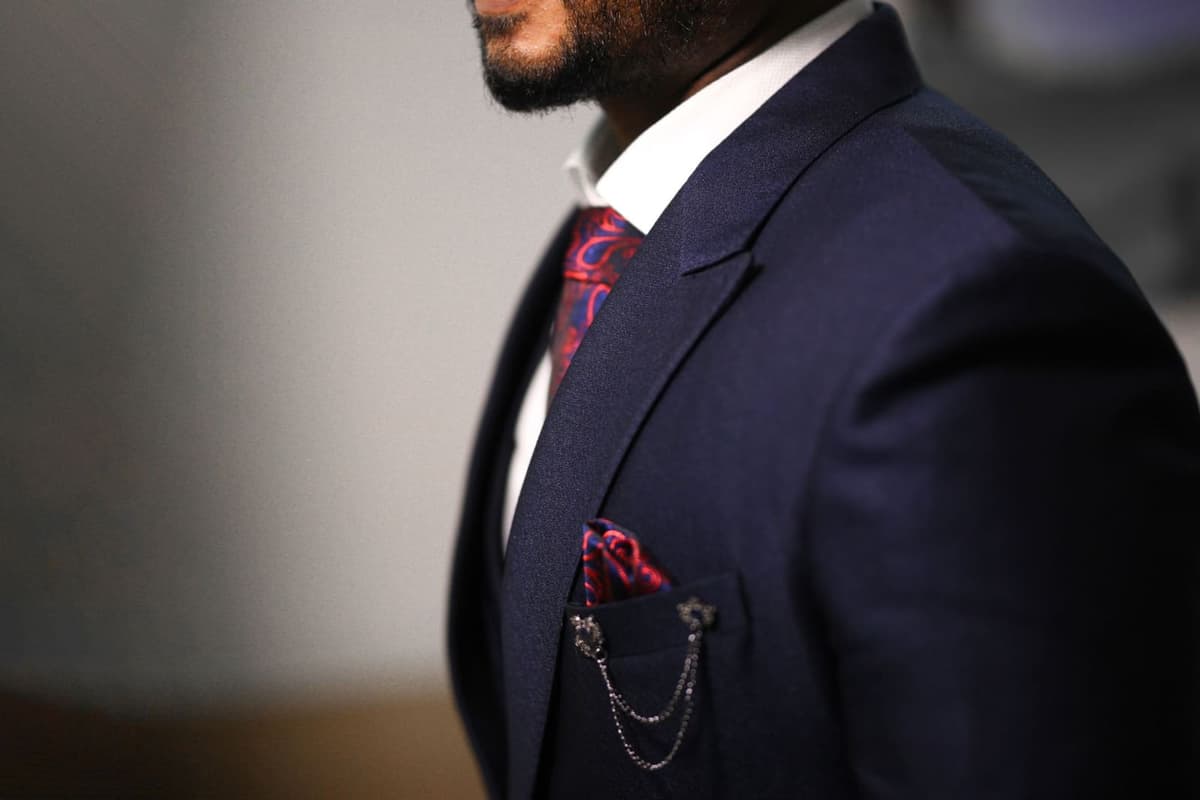 Close-up of a tailored jacket lapel and chest, showing the lapel notch, roll and buttonhole detail
