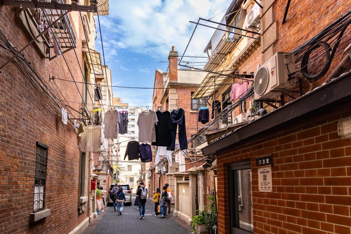 Quiet early-morning city alley with soft light and muted tones evoking the Chinamaxxing lifestyle aesthetic