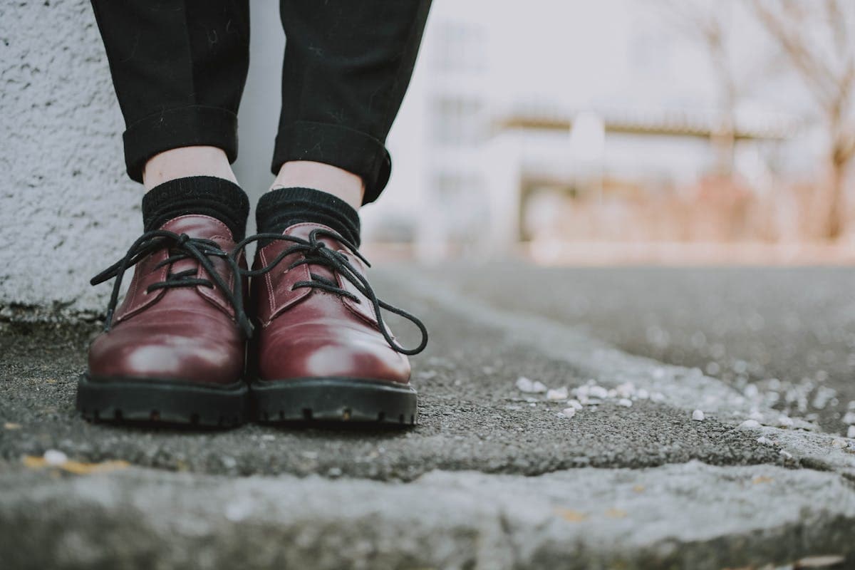 Close-up of a slim tapered-ankle trouser break over a pointed dress shoe, the silhouette this article advises retiring