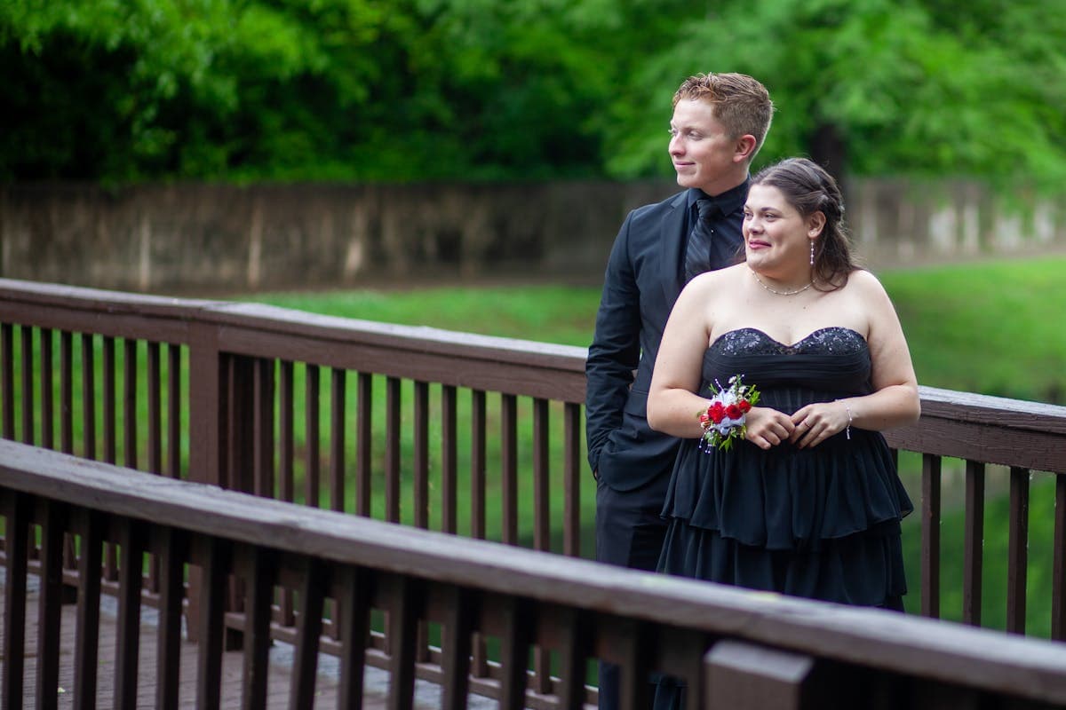 Young prom couple in coordinated formal attire, the suit accents matching the dress color