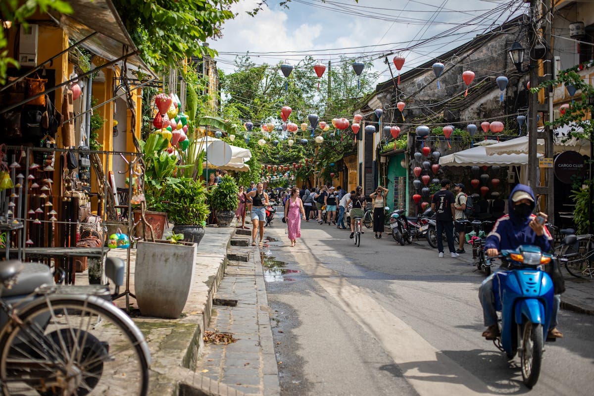 A tailor shop storefront on a lantern-lined street in Hoi An, Vietnam's old town