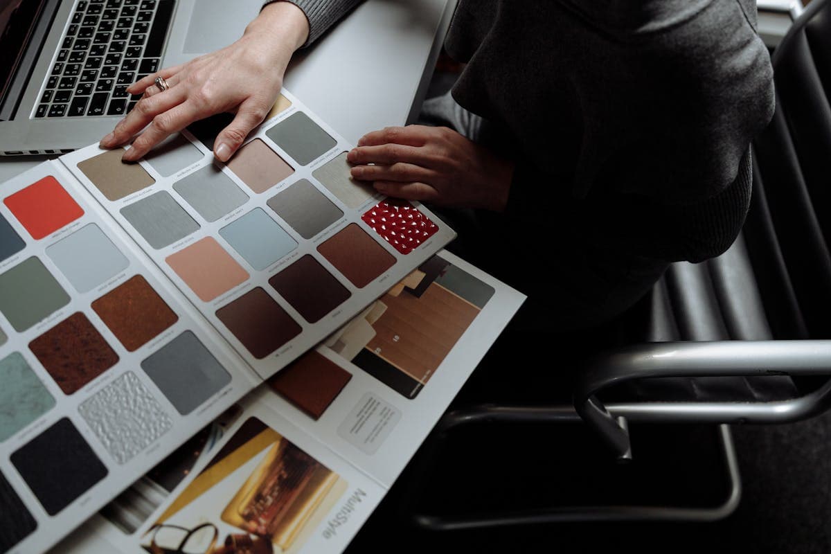 Laptop open beside fabric swatches representing the online made-to-measure ordering experience