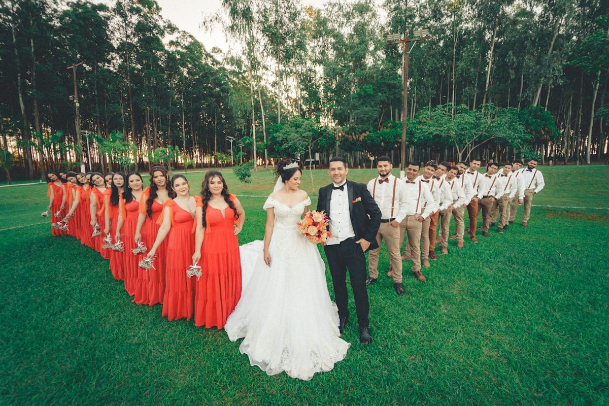 Groom and groomsmen standing together in coordinated tailored suits at a wedding