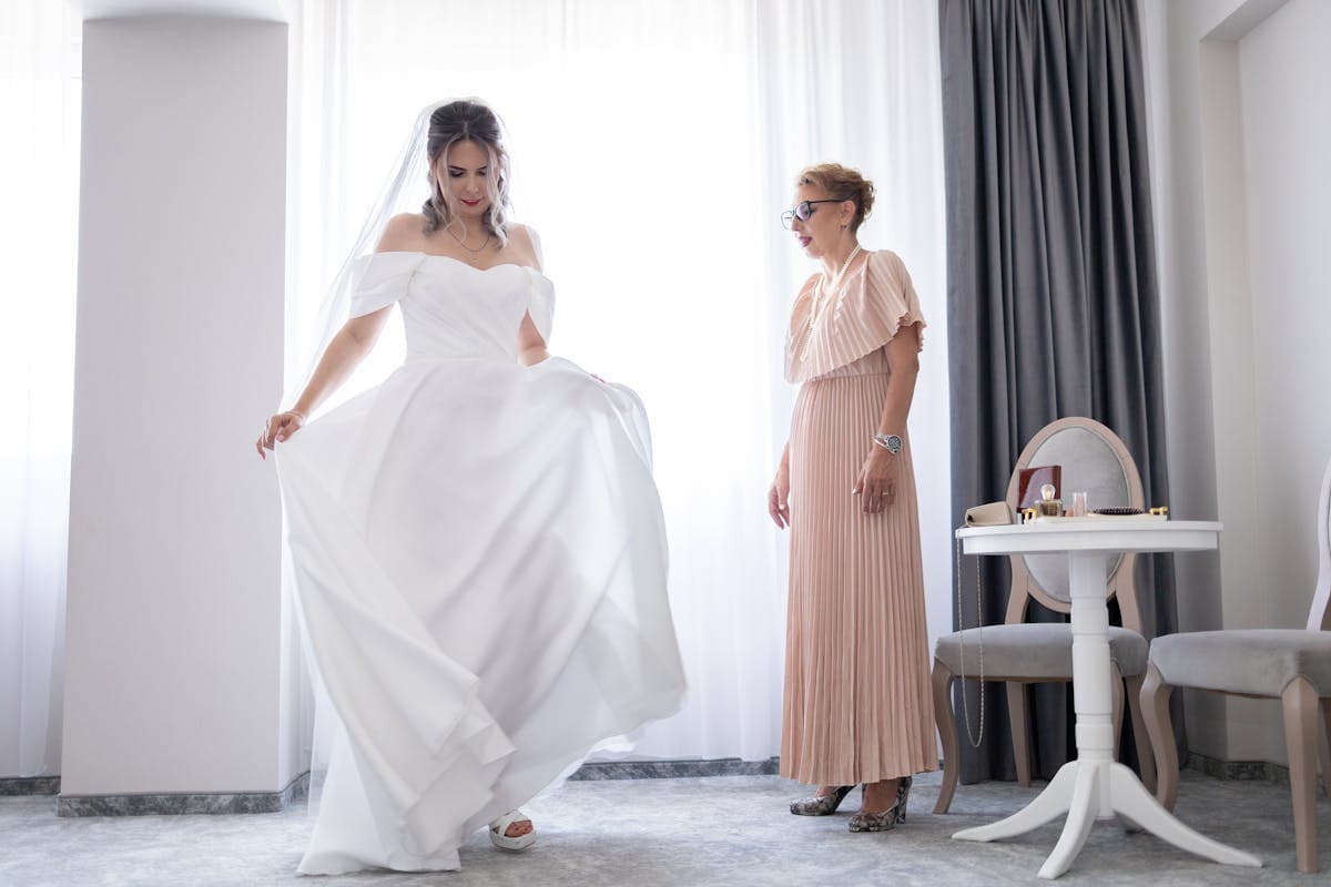 Elegantly dressed mother of the bride at a wedding wearing a custom-fitted outfit
