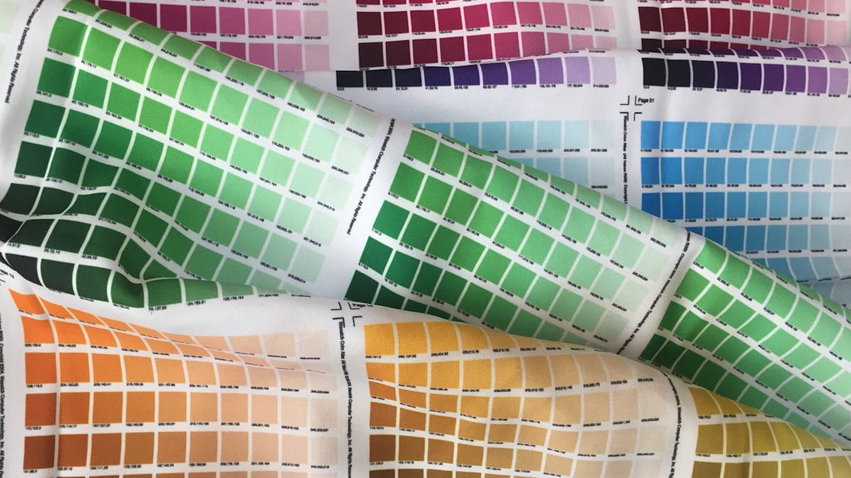 Close-up of cotton dress shirt fabric swatches showing different weaves -- poplin, twill, and end-on-end
