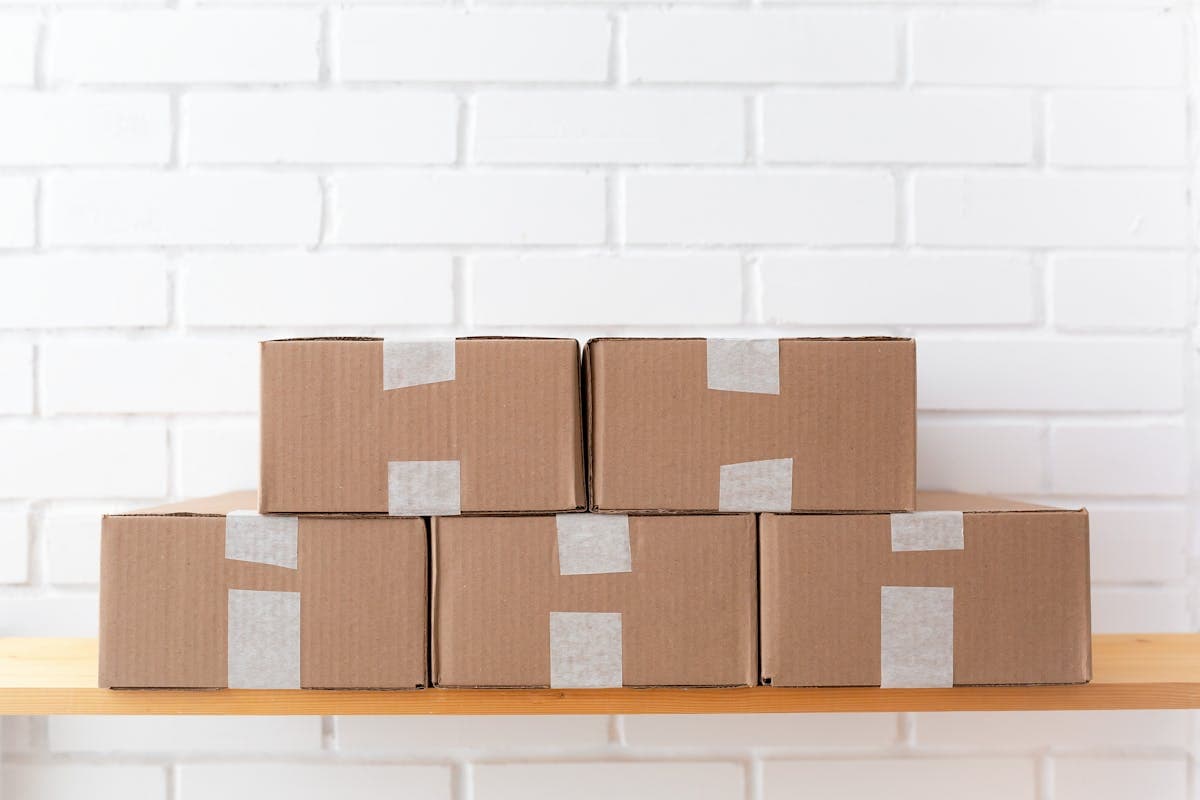 Stacked cardboard shipping boxes ready to be sealed for international courier delivery