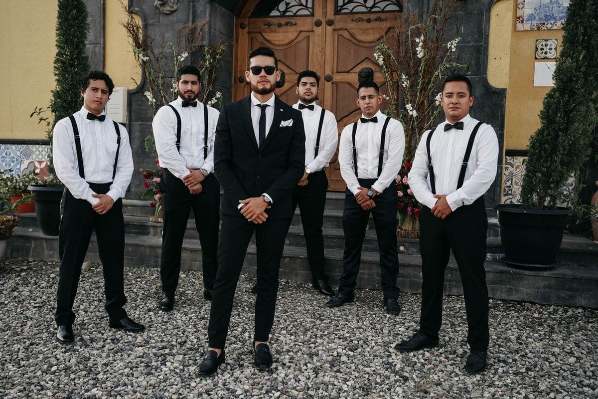 Group of groomsmen standing together in coordinated tailored suits
