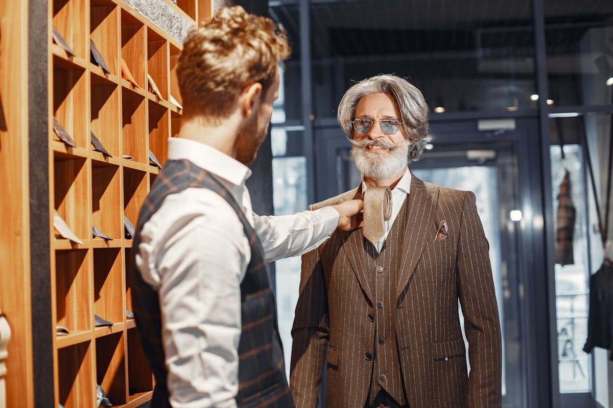 Older man in a loose off-the-rack suit jacket that does not fit well at the shoulders