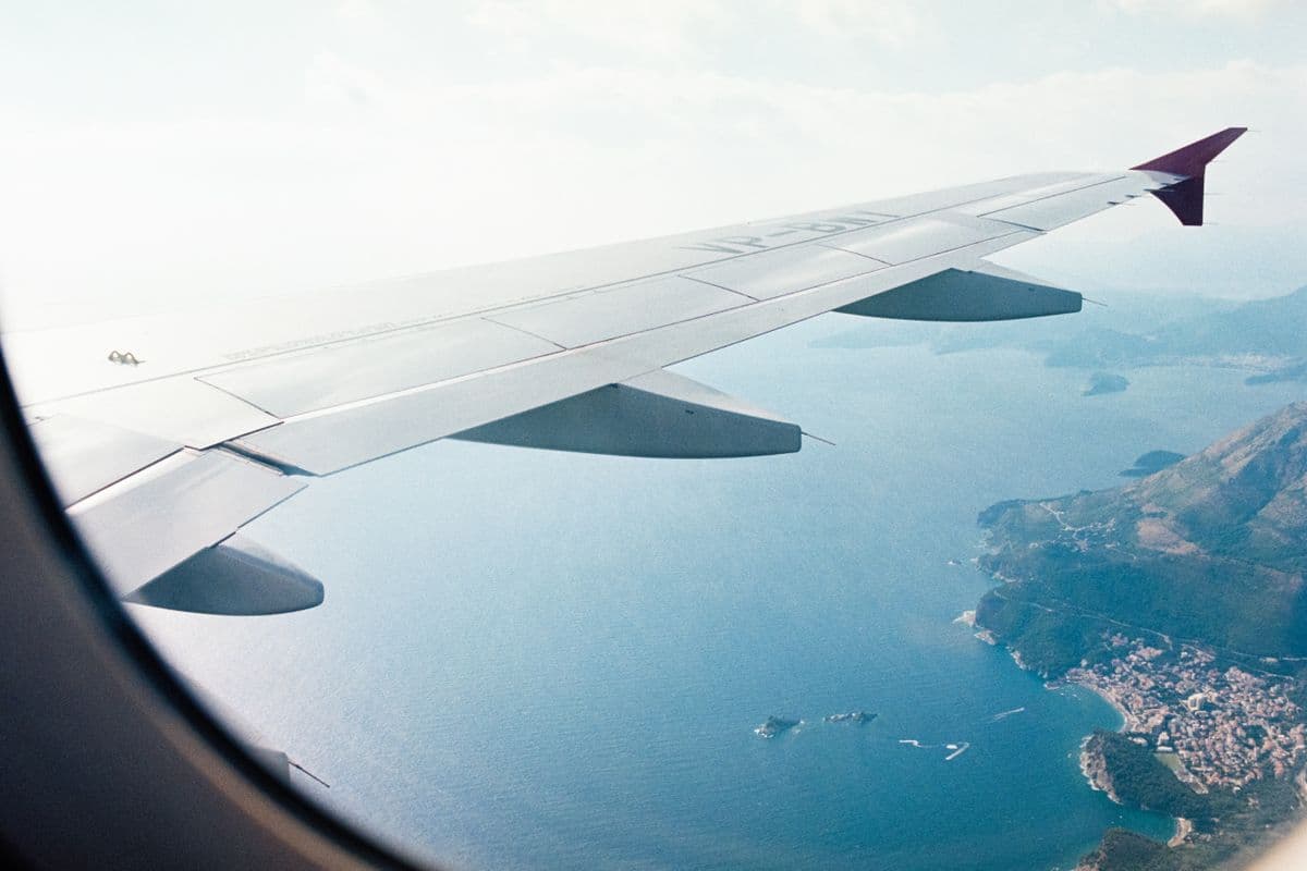 Aircraft wing over the central Vietnam coastline on approach to Da Nang, beaches and green hills below