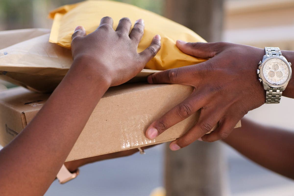 Courier handling a sealed cardboard shipping box for international delivery