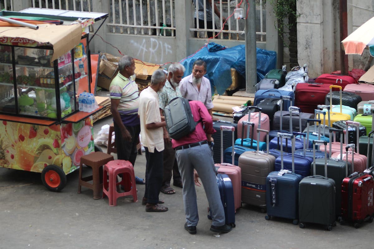 Rows of inexpensive rolling suitcases for sale at a Vietnamese market stall