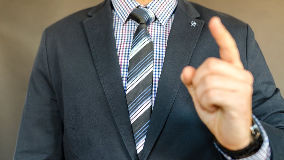 Man in a blazer with open collar shirt, relaxed summer style, no tie