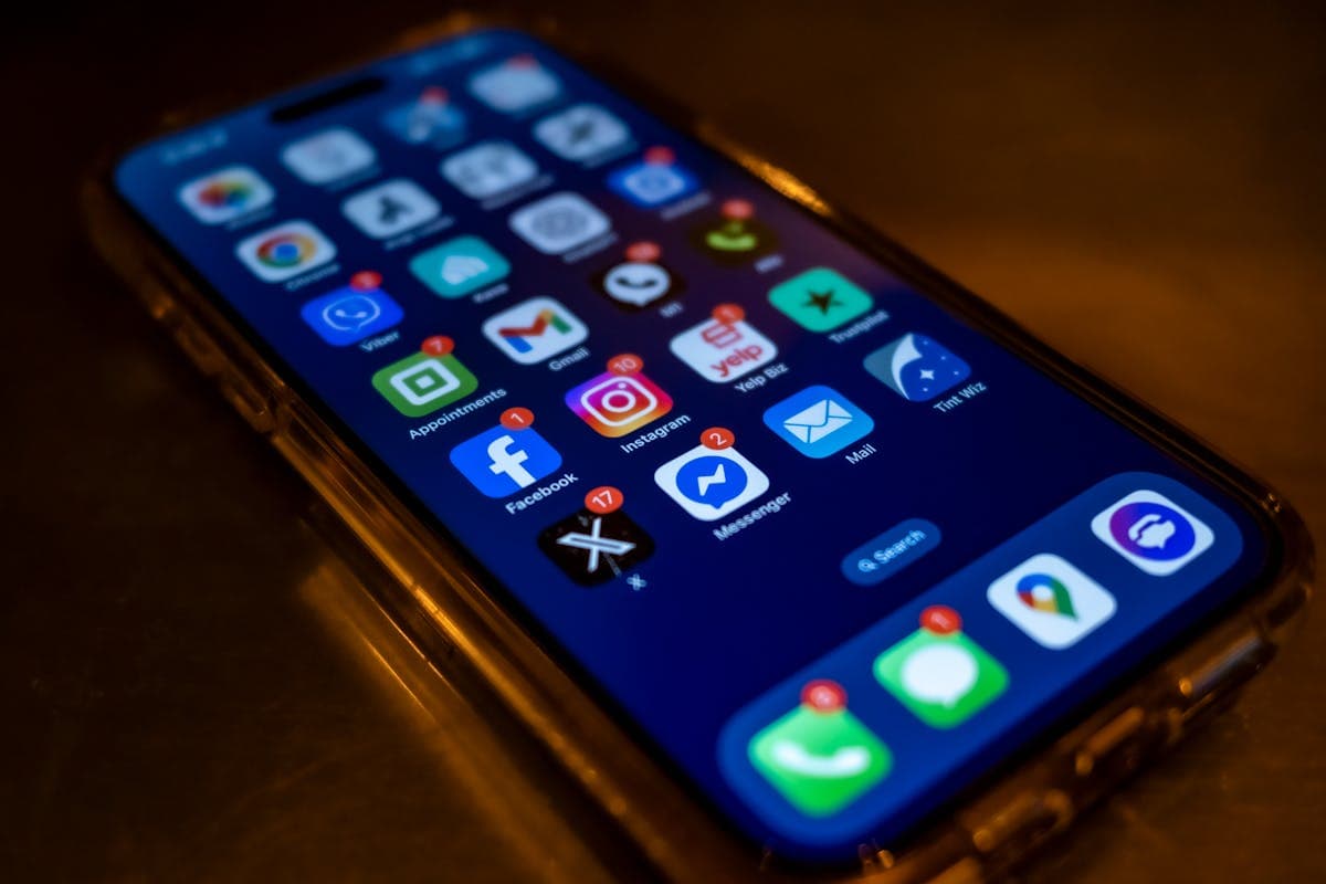 Glowing smartphone showing a messaging chat interface at night, representing fabric and sizing questions being answered around the clock