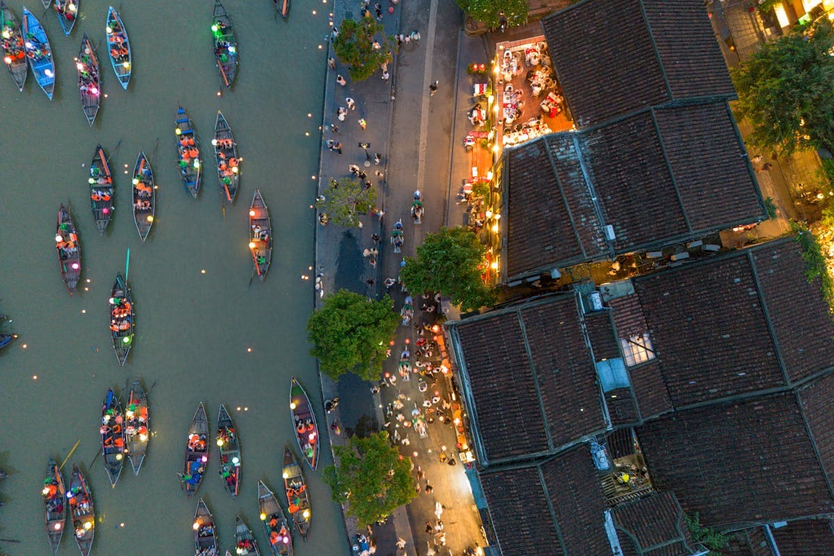 Lantern-lit historic Hoi An old town at dusk, the four-hundred-year-old tailoring hub where Nathan Tailors hand-makes its garments