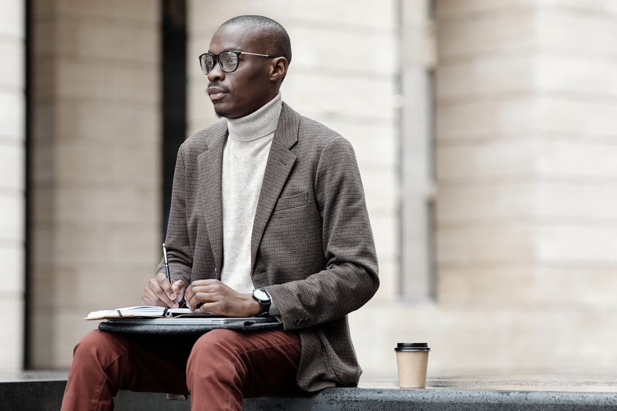 Stylish man in a textured colored blazer and turtleneck with relaxed tailoring in a creative studio setting