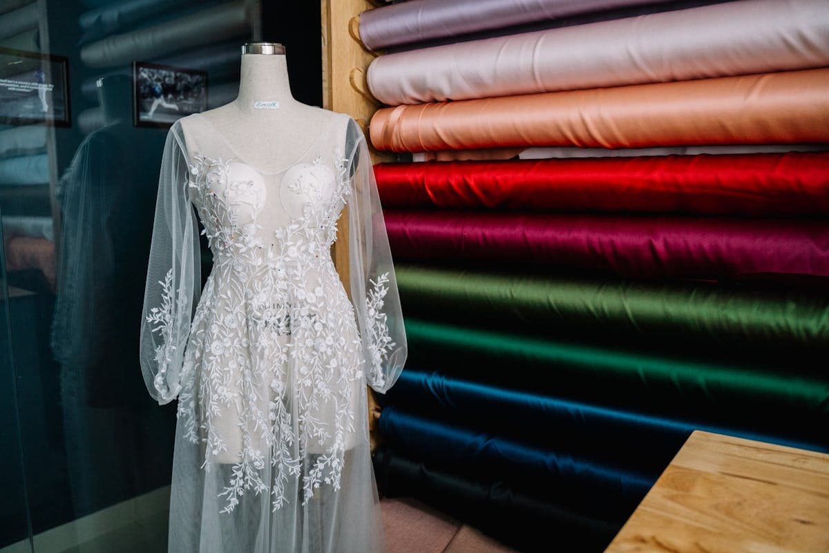 Interior of a Hoi An tailor shop with bolts of suiting fabric and finished garments