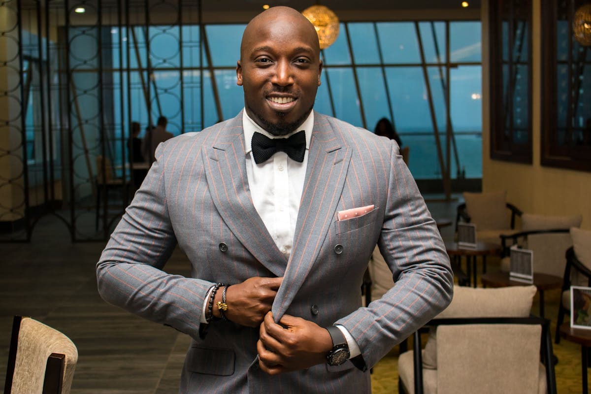 Man wearing a modern double-breasted suit worn open with peak lapels and no tie