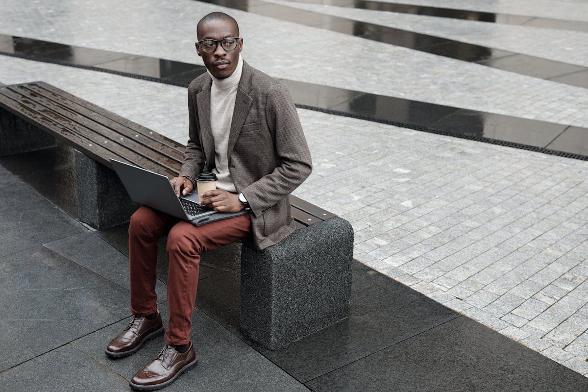 A burgundy blazer styled separately with gray trousers in a relaxed setting, showing how the piece keeps working after the premiere