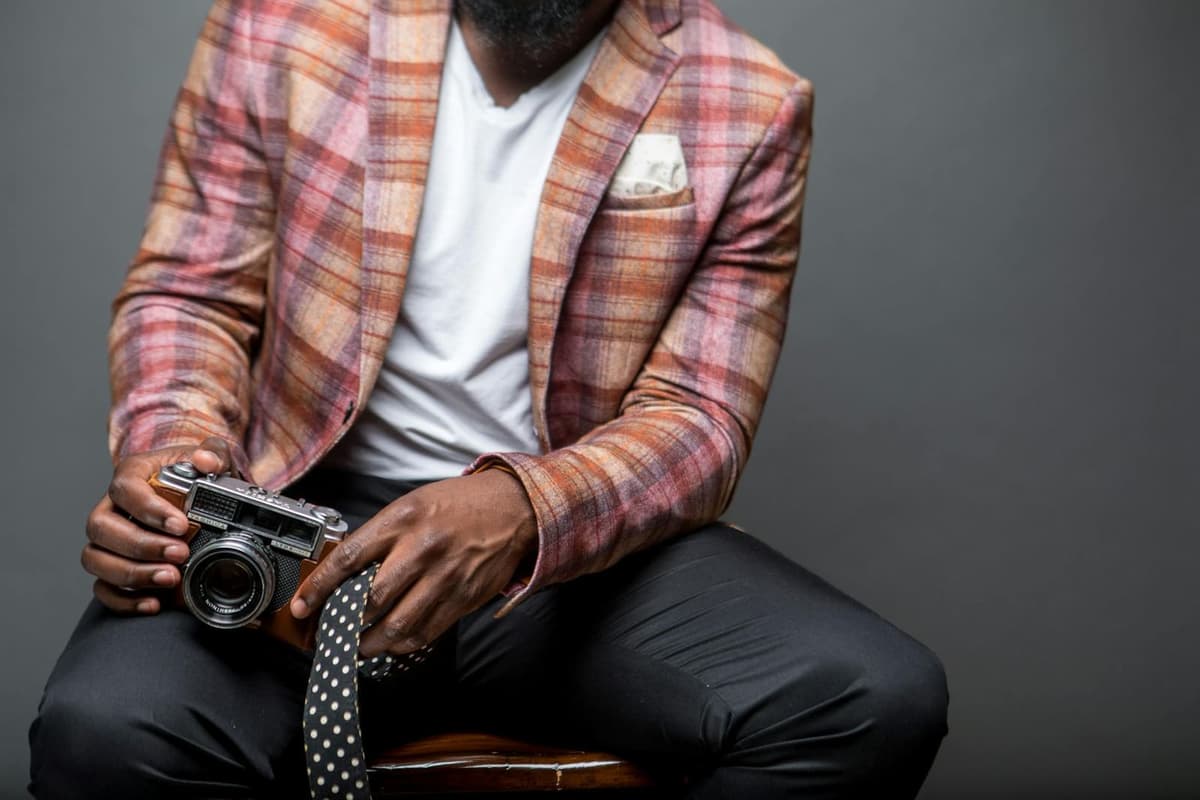 A deep burgundy wool blazer on a mannequin, peak lapel and structured shoulder echoing the military cut of the 1983 Thriller jacket