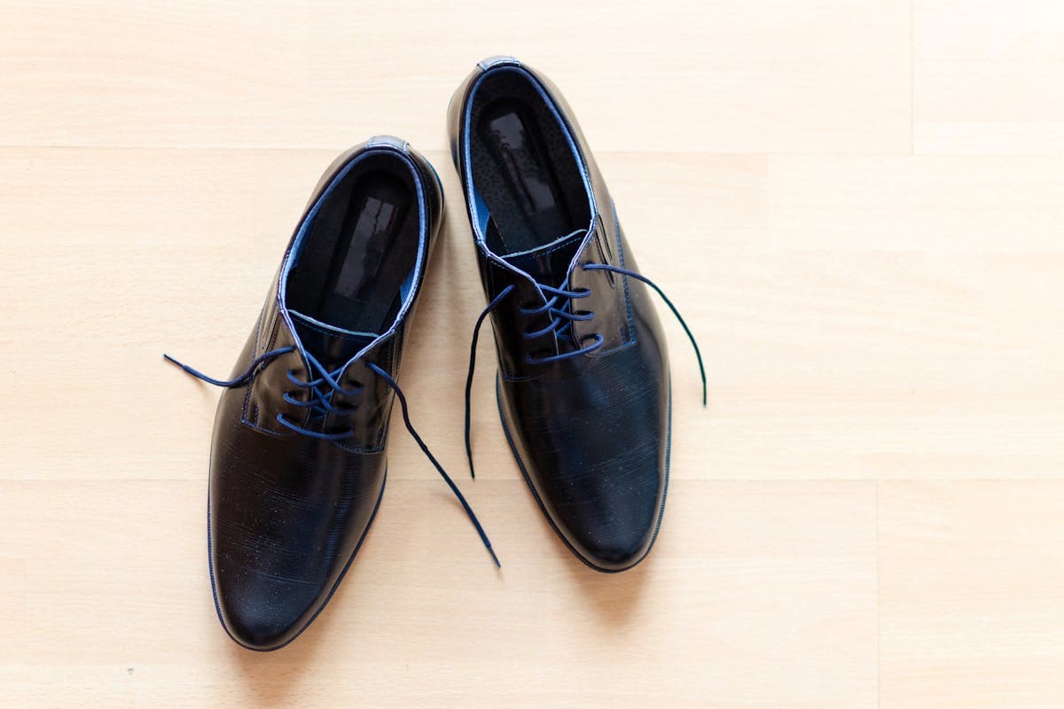 Close-up of a clean white wholecut oxford dress shoe, the footwear that finishes the Michael Jackson white suit without resorting to costume spats