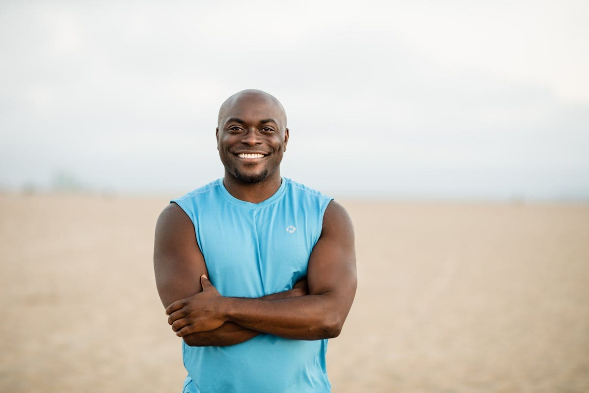 Relaxed, confident man in a well-fitted shirt smiling naturally in an urban setting