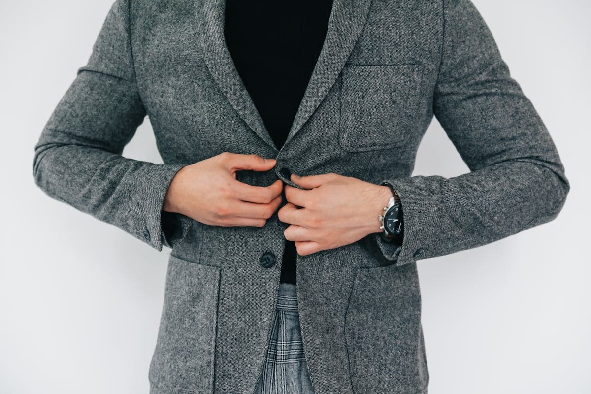 Well-dressed man in a sharply fitted tailored jacket showing clean shoulder line and silhouette