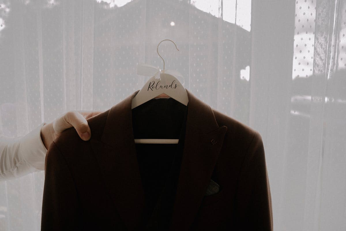 A finished tailored suit jacket hanging ready for collection, representing the identical garment quality whether ordered in person in Hoi An or remotely