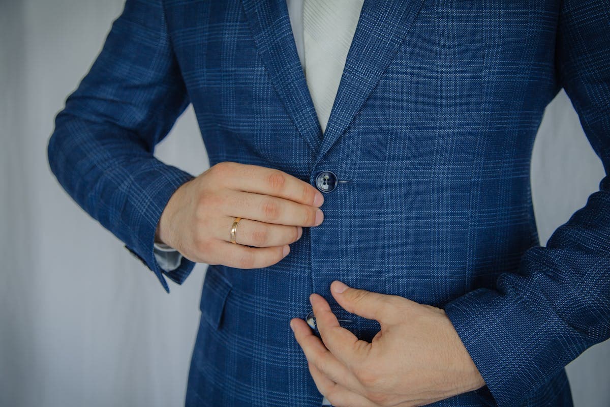Close-up of a buttoned suit jacket front showing the chest and lapel lying flat against the body
