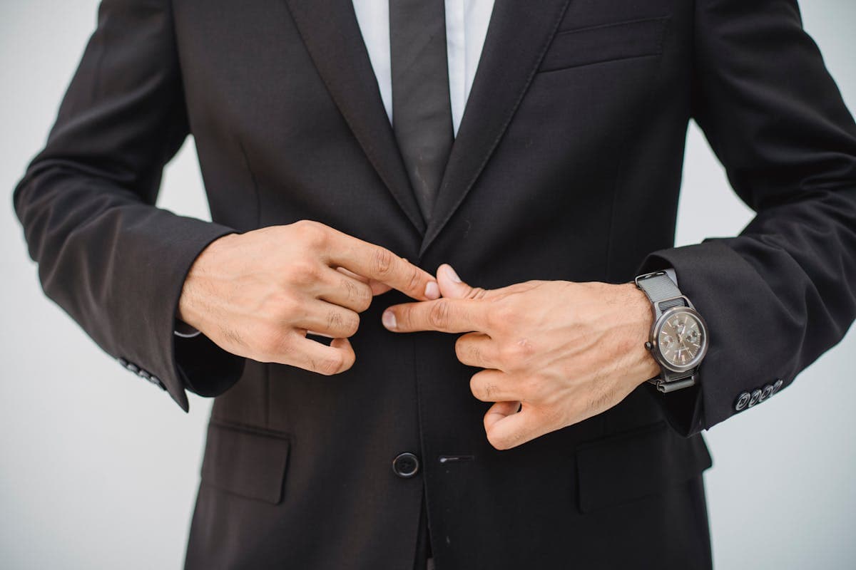 Athletic man in a buttoned suit jacket where the lapel lifts slightly away from the chest
