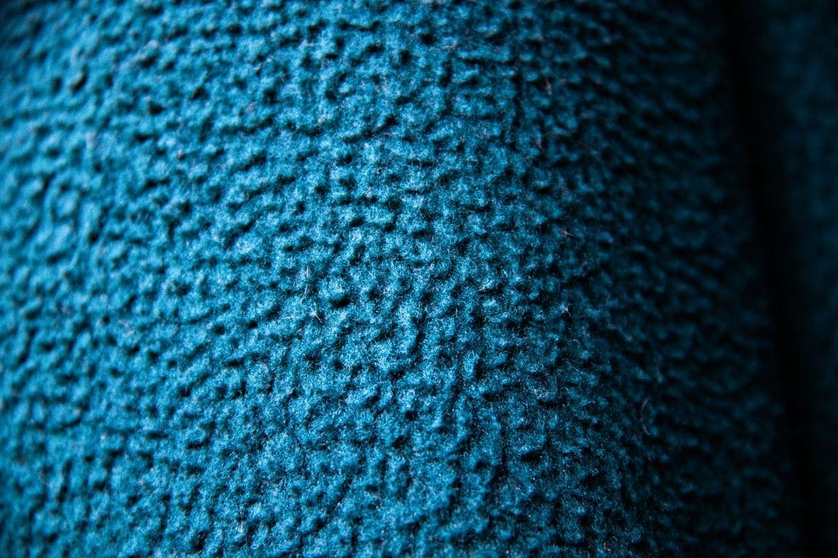 Close-up of navy wool suiting cloth showing weave and drape, the kind of textile fidelity we tested image models against