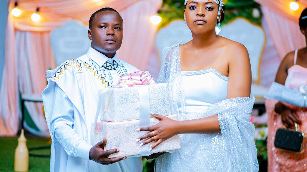 Couple in elegant wedding attire exchanging gifts in a beautifully decorated setting