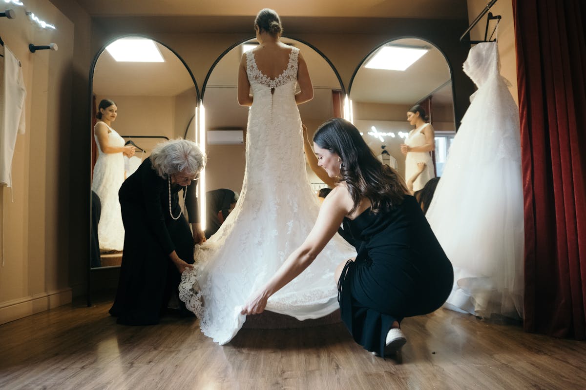 Bride admiring custom-made wedding dress in fitting room