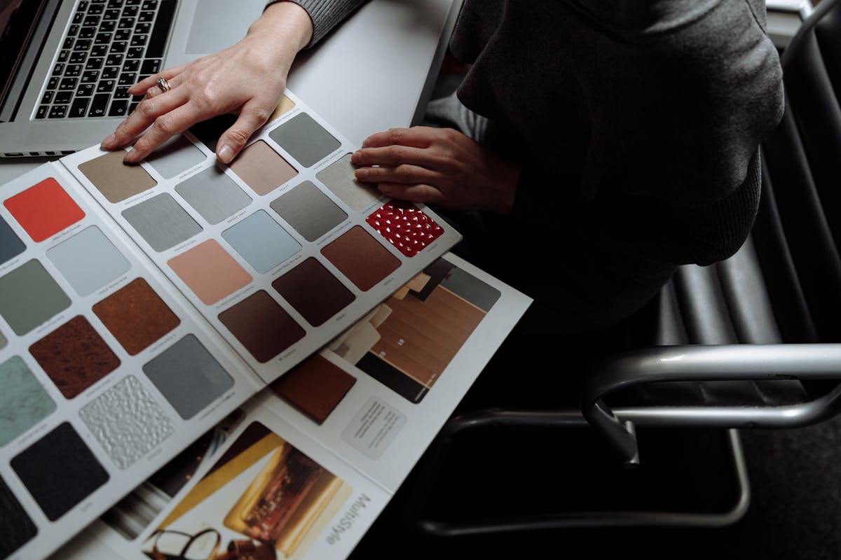 Laptop open beside fabric swatches representing the online made-to-measure ordering experience