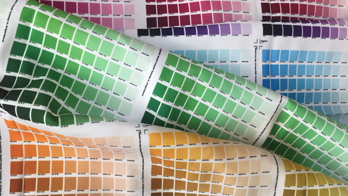 Close-up of cotton dress shirt fabric swatches showing different weaves -- poplin, twill, and end-on-end