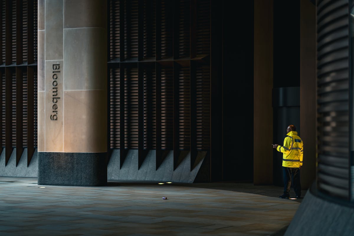 A bank of glowing financial data screens on a dimly lit trading desk before the market opens