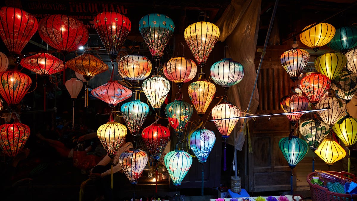 Colorful paper lanterns illuminating a street in Hoi An, Vietnam at night