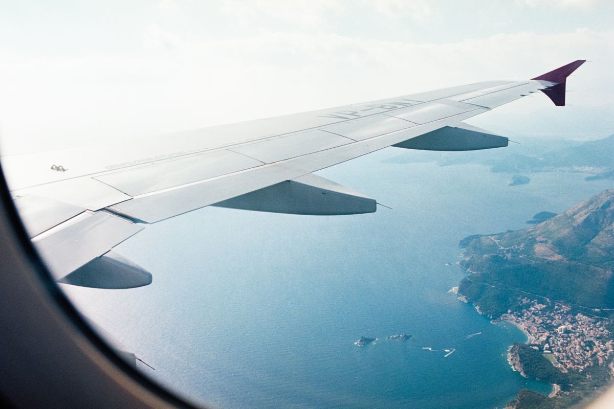 Aircraft wing over the central Vietnam coastline on approach to Da Nang, beaches and green hills below