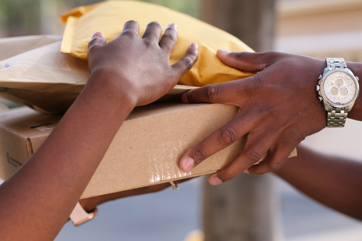 Courier handling a sealed cardboard shipping box for international delivery