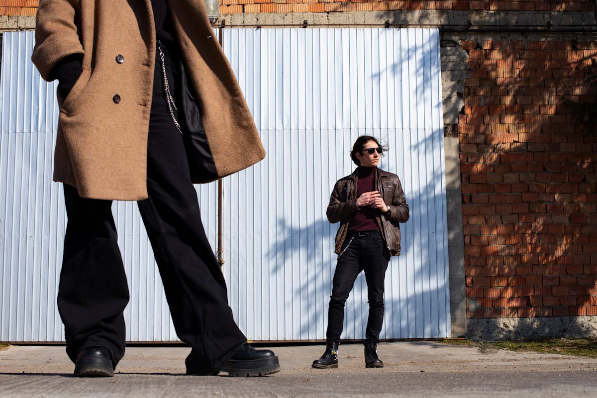 Well-dressed man in an unstructured double-breasted suit with an open collar and no tie on a city street