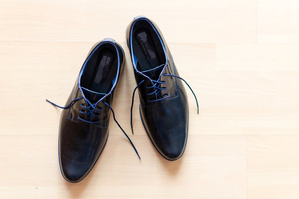 Close-up of a clean white wholecut oxford dress shoe, the footwear that finishes the Michael Jackson white suit without resorting to costume spats