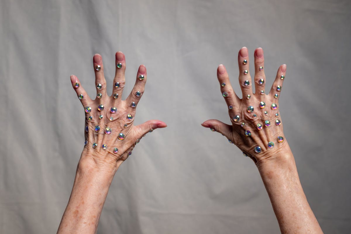 A single white rhinestone-covered glove against a dark background