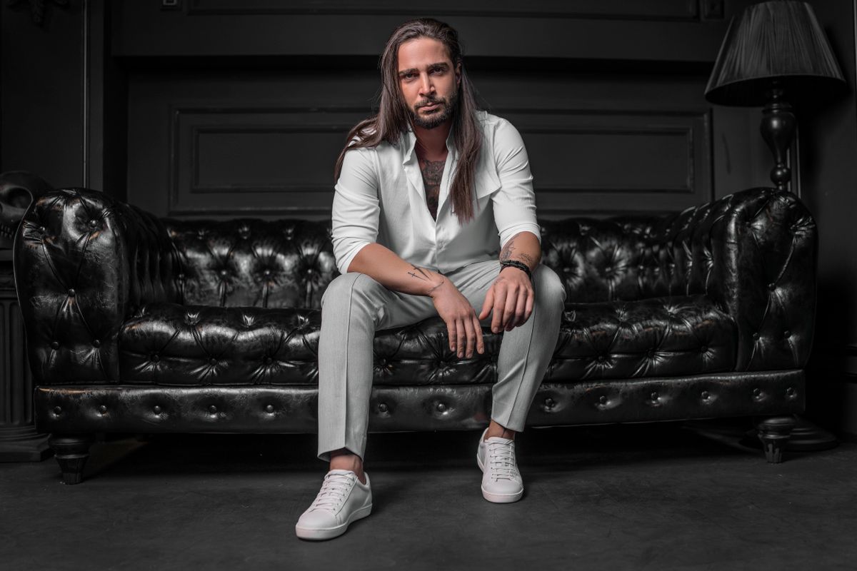 Young man in a sharp head-to-toe white suit walking confidently, echoing the all-white draft-night statement look