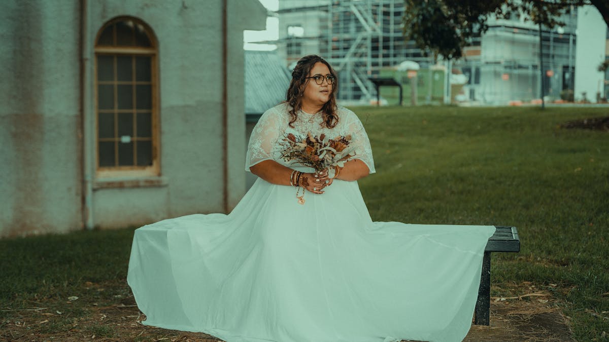 Plus-size bride in beautifully fitted custom wedding dress