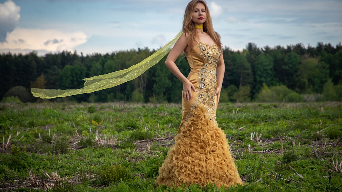 Young woman in an elegant formal gown radiating confidence -- prom should feel exactly like this for everyone