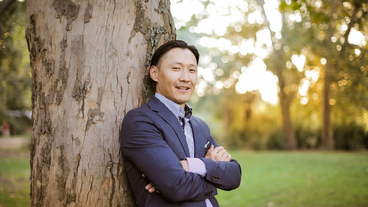 Group of young adults in formal attire celebrating outdoors at a formal event