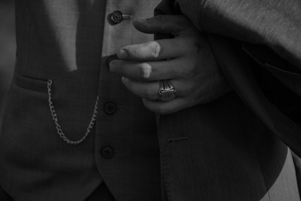 A vintage 1930s-style double-breasted suit with wide peak lapels photographed in warm low light, evoking the Club 30's speakeasy aesthetic