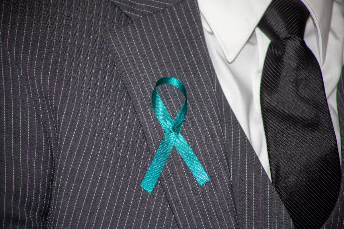 Close-up of a suit jacket collar and lapel sitting against a shirt collar at the back of the neck